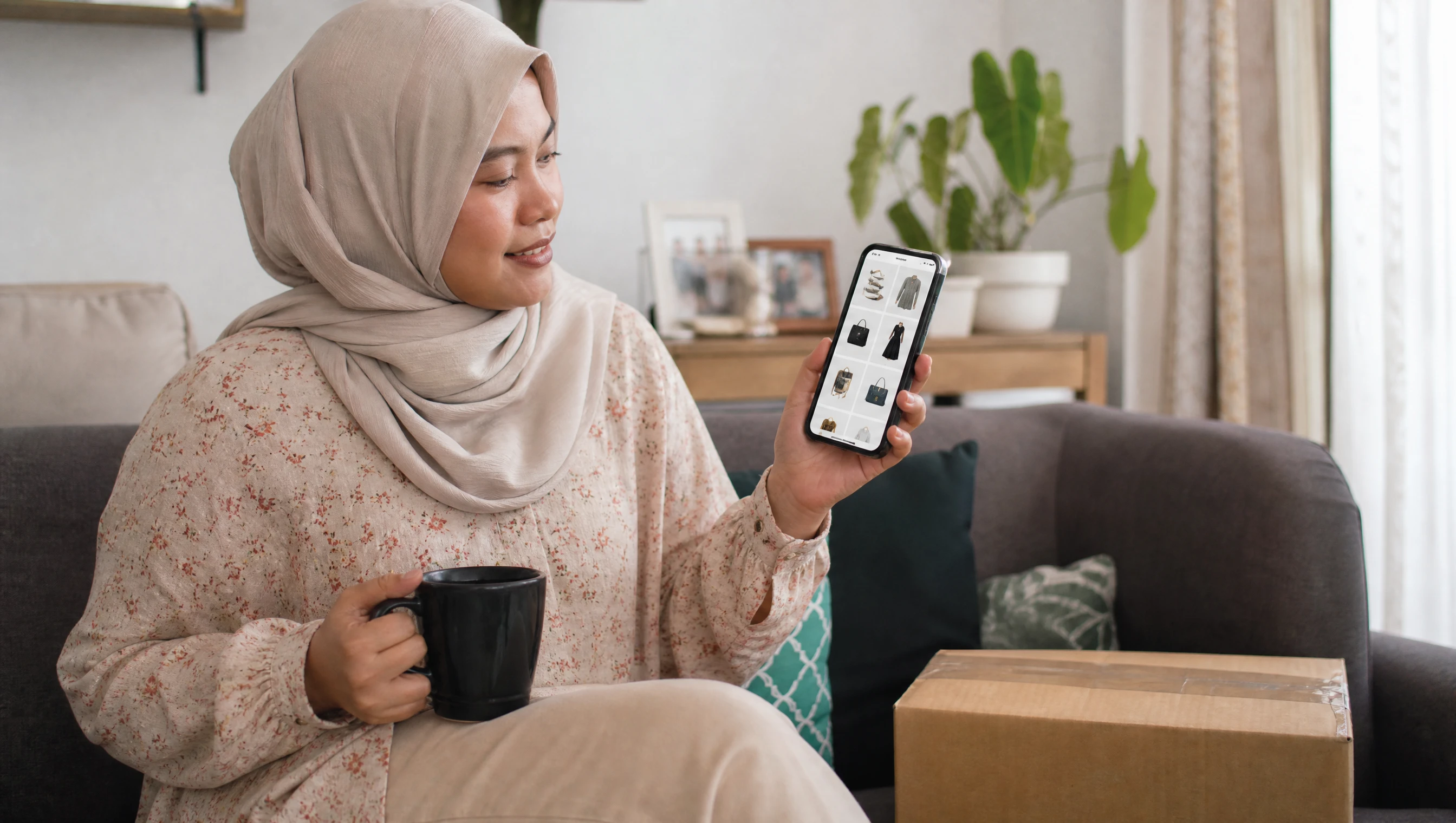 Malaysian woman shopping on a native mobile shopping app at home